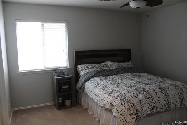 a view of a backyard with wooden fence