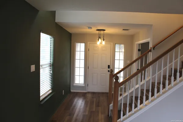 a view of an entryway with wooden floor and windows