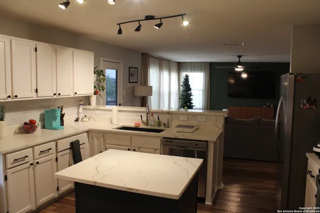 a kitchen with sink cabinets and wooden floor