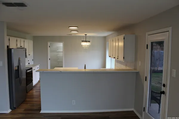 a kitchen with stainless steel appliances a refrigerator sink and stove