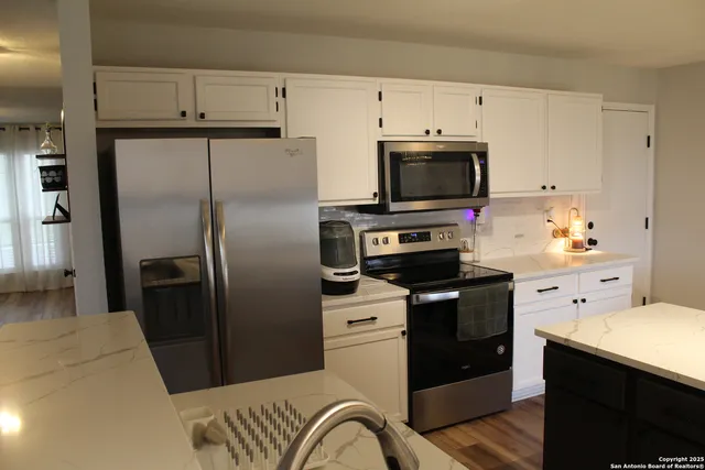 a kitchen with a refrigerator stove and microwave