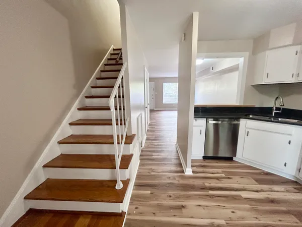 a view of entryway and hall with wooden floor