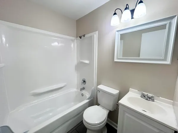 a white toilet sitting next to a bathroom sink