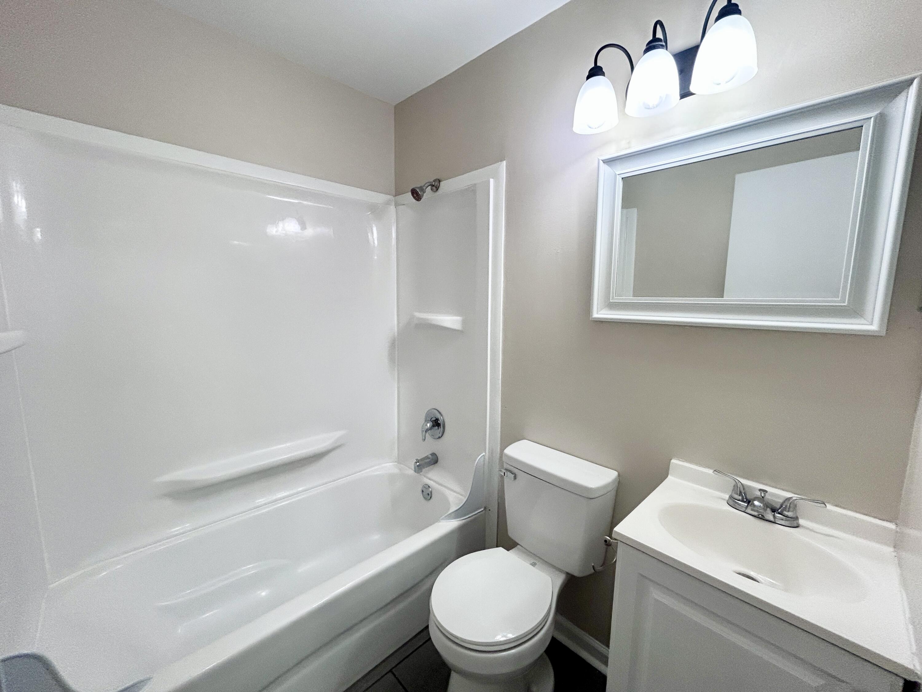 1803 Grandin Road Southwest Roanoke, VA 24015 - Photo 22 of 33 a white toilet sitting next to a bathroom sink