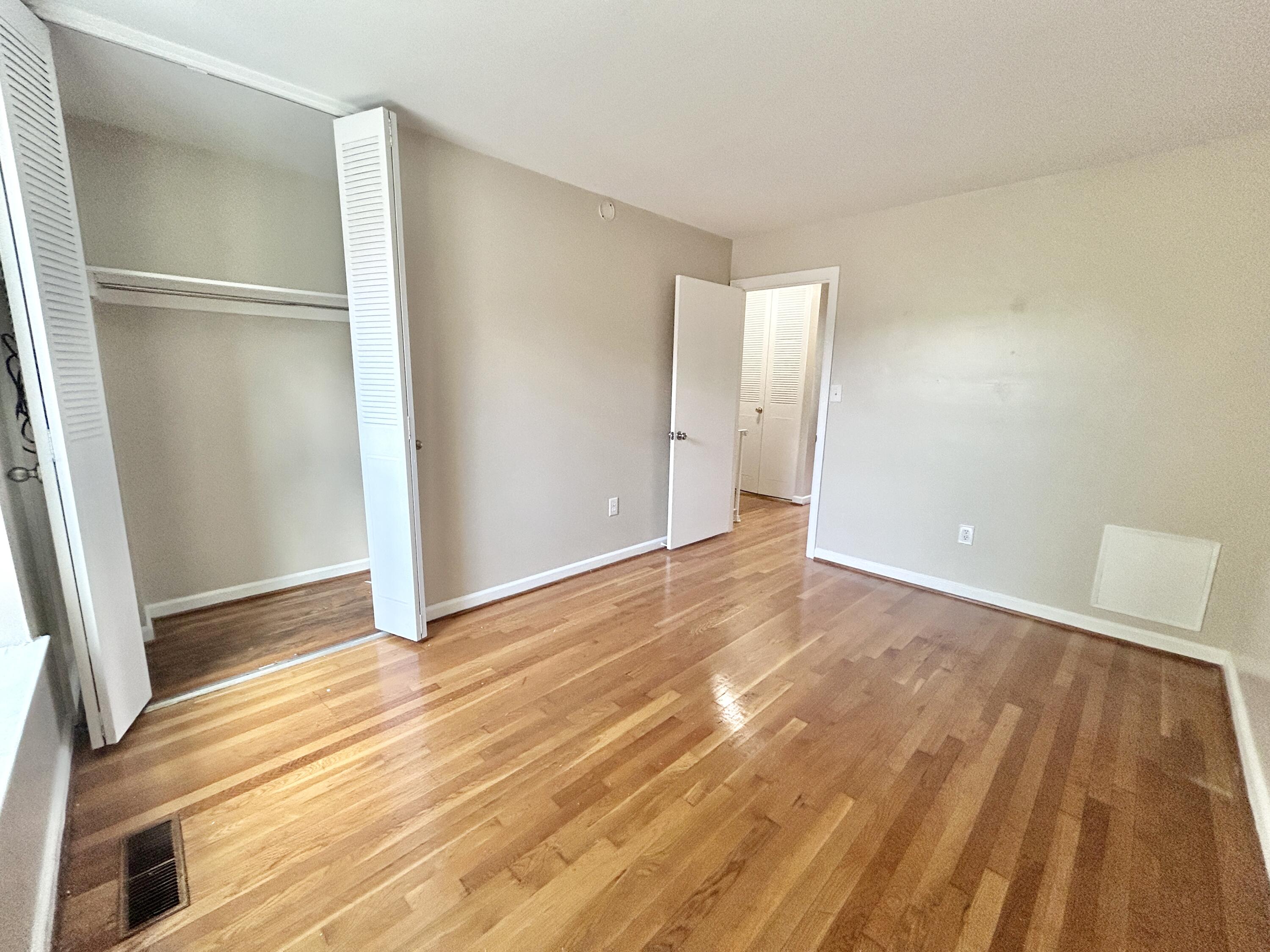 1803 Grandin Road Southwest Roanoke, VA 24015 - Photo 23 of 33 a view of an empty room with wooden floor and a window