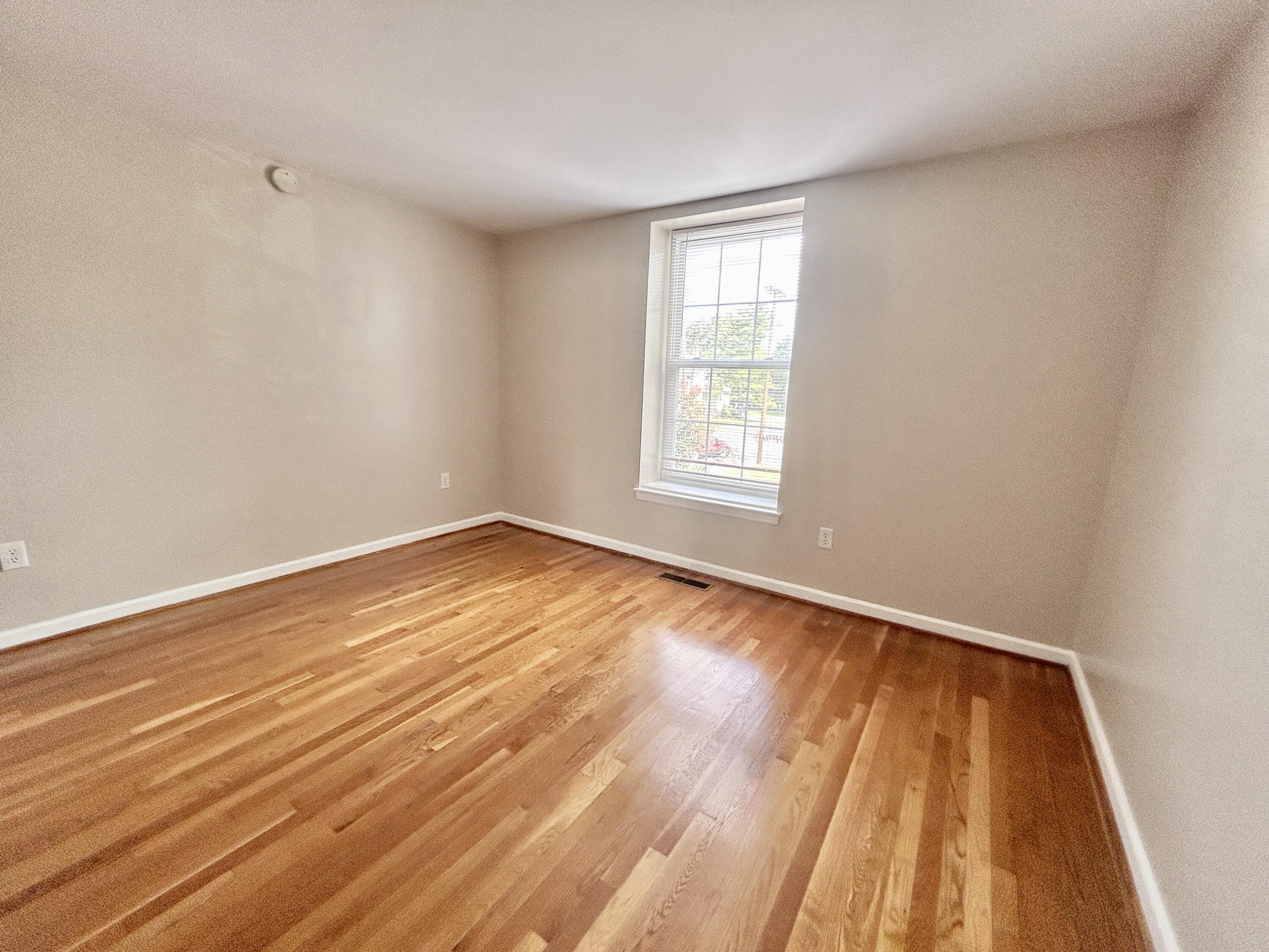 1803 Grandin Road Southwest Roanoke, VA 24015 - Photo 25 of 33 an empty room with wooden floor and windows