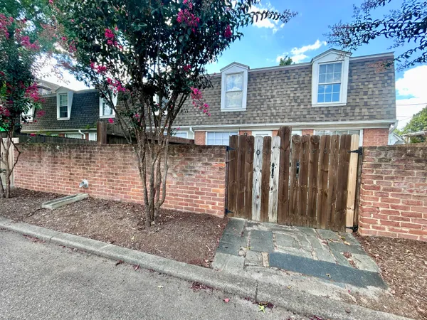 a front view of a house with tree s
