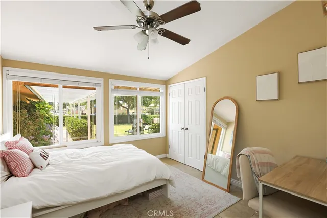 a bedroom with a bed a fireplace and a large window