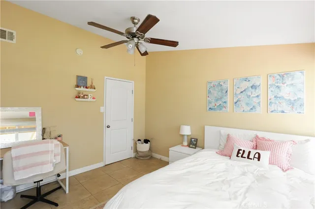 a bedroom with a bed and a desk