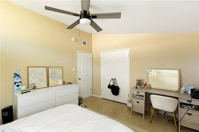 a bedroom with a bed a table and chair