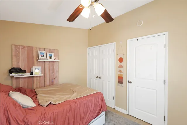 a spacious bedroom with a bed and a chandelier