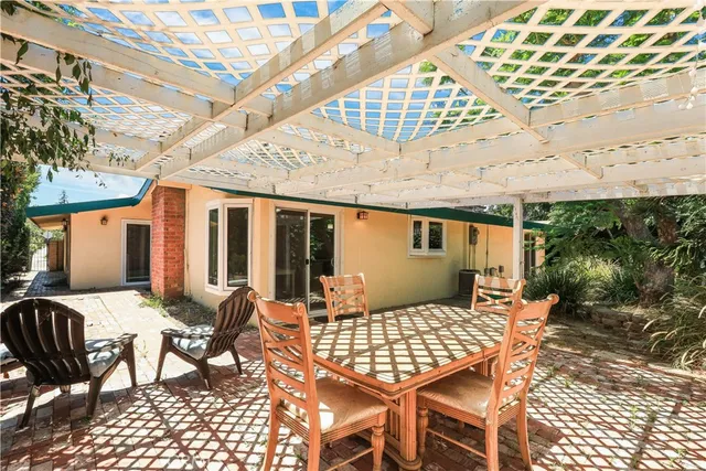 a view of a patio with table and chairs and potted plants