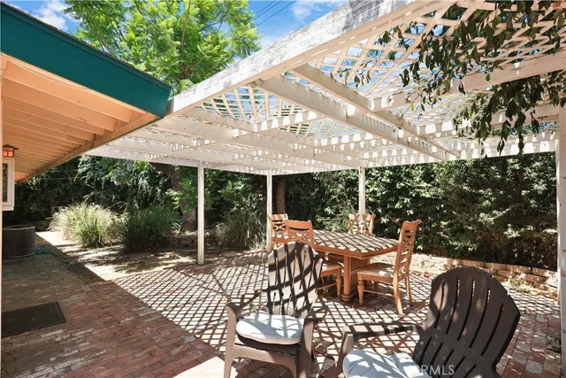 a view of a house with backyard porch and sitting area