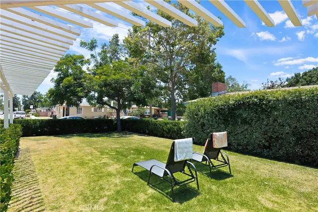 a view of a swimming pool with a patio and a yard