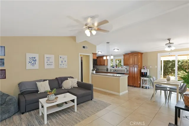 a living room with furniture and kitchen view