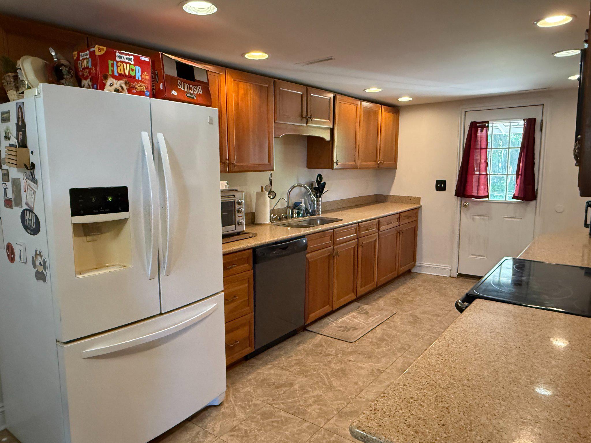 4818 Piney Neck Road Rock Hall, MD 21661 - Photo 4 of 24 a kitchen with stainless steel appliances a refrigerator sink and cabinets