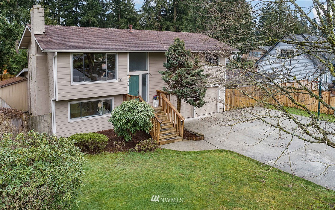 21723 2nd Avenue Southeast Bothell, WA 98021 - Photo 1 of 27 a front view of a house with a yard