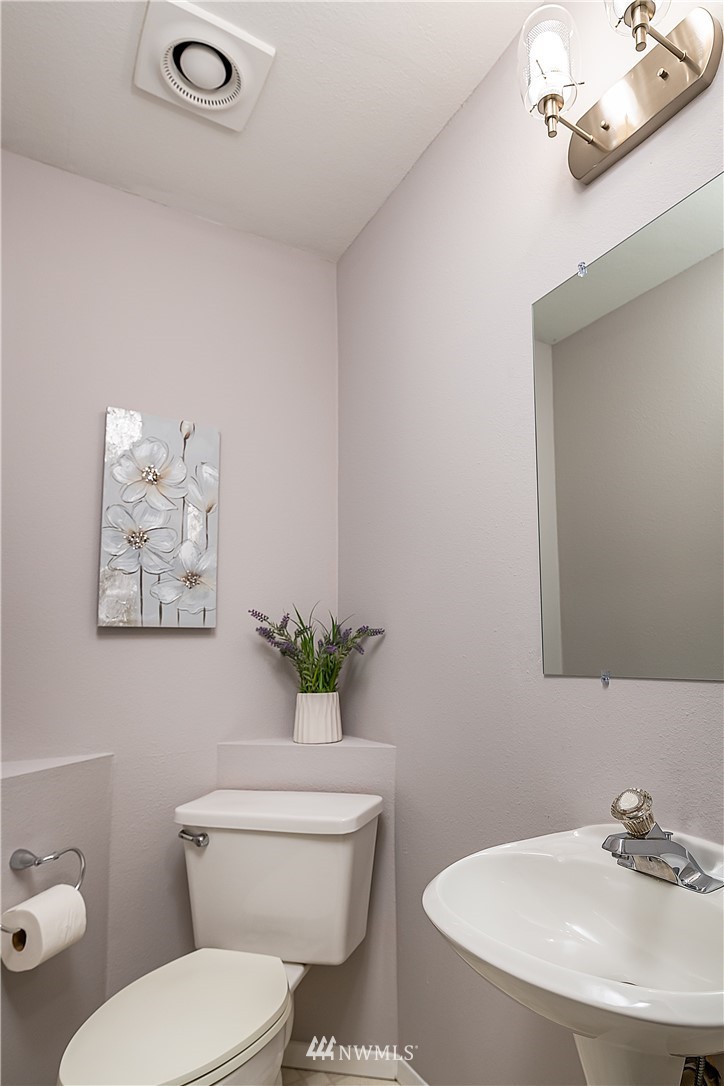 21723 2nd Avenue Southeast Bothell, WA 98021 - Photo 13 of 27 a bathroom with a toilet a sink and mirror