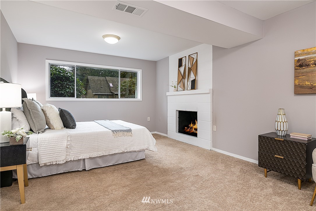 21723 2nd Avenue Southeast Bothell, WA 98021 - Photo 14 of 27 a spacious bedroom with a bed and a fireplace