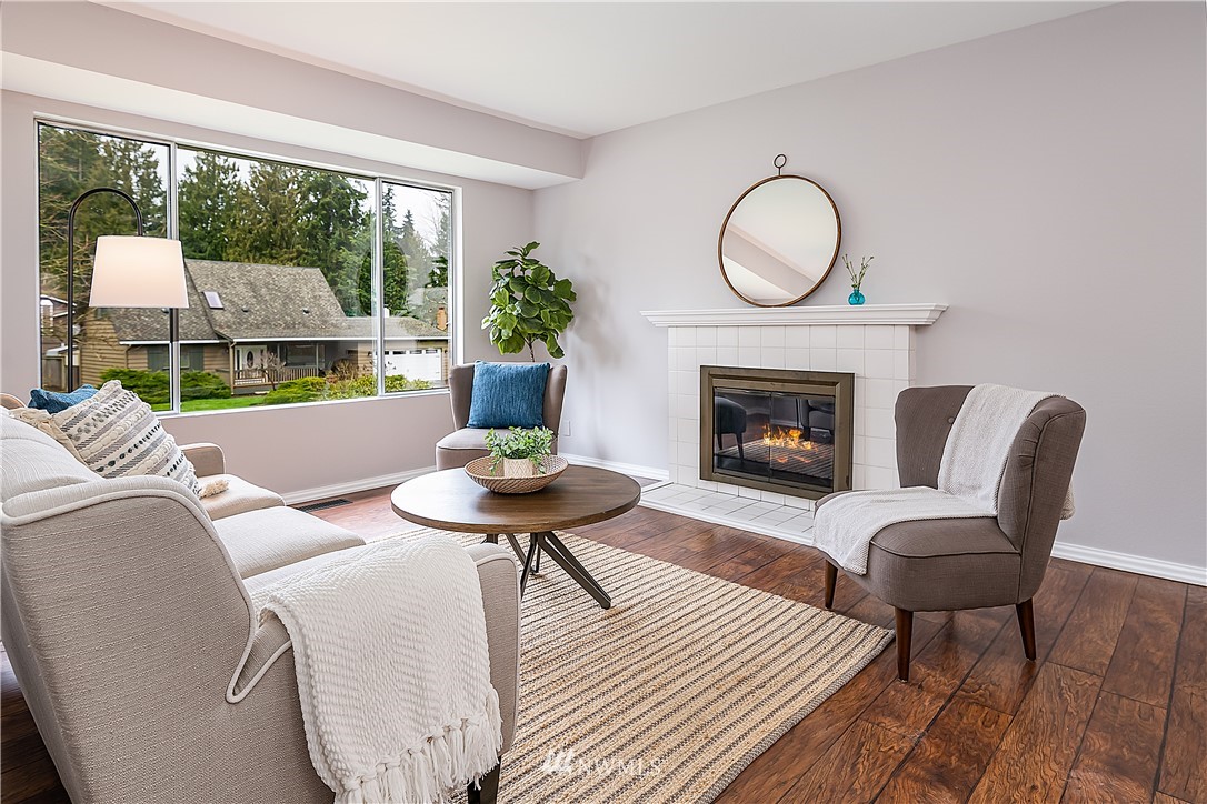 21723 2nd Avenue Southeast Bothell, WA 98021 - Photo 3 of 27 a living room with furniture a fireplace a large window and a large window