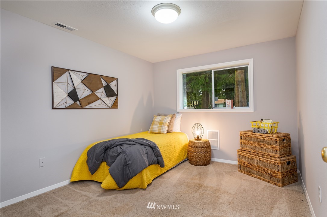 21723 2nd Avenue Southeast Bothell, WA 98021 - Photo 21 of 27 a bedroom with a bed and a window