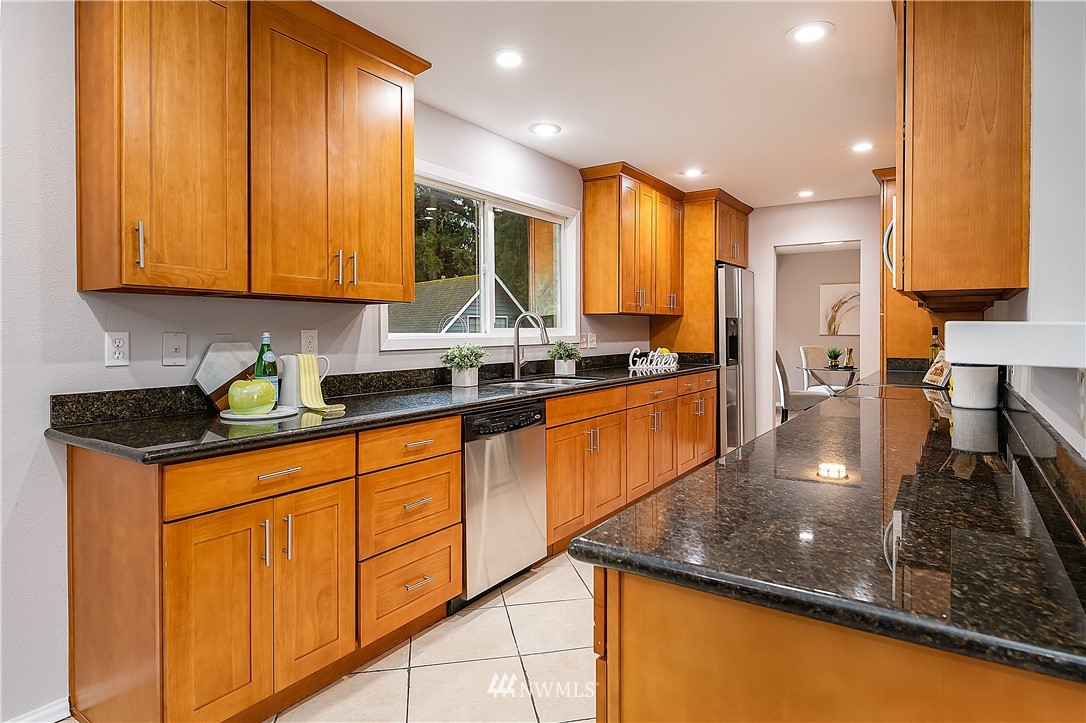 21723 2nd Avenue Southeast Bothell, WA 98021 - Photo 6 of 27 a kitchen with stainless steel appliances granite countertop sink stove and cabinets
