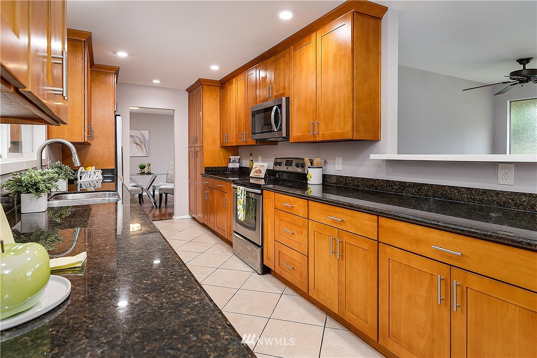 21723 2nd Avenue Southeast Bothell, WA 98021 - Photo 7 of 27 a kitchen with stainless steel appliances granite countertop sink stove and cabinets