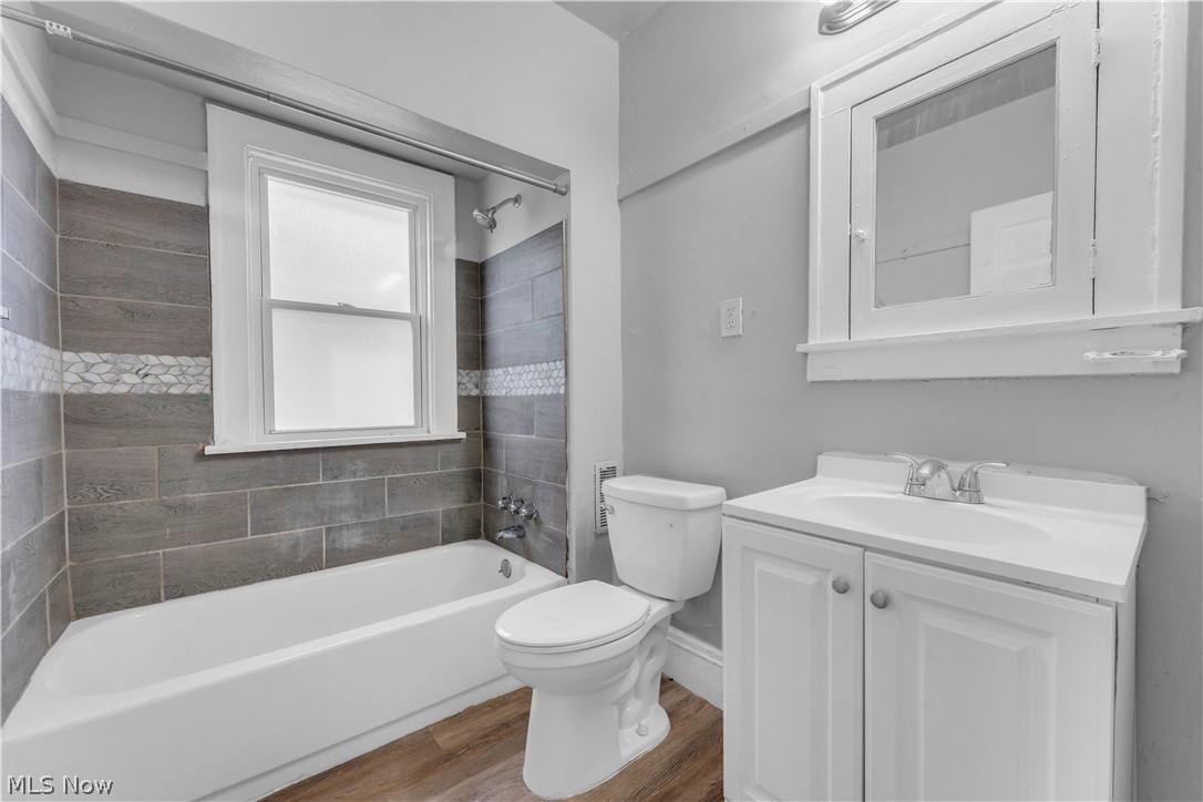860 Greyton Road Cleveland Heights, OH 44112 - Photo 28 of 31 Full bathroom with hardwood / wood-style flooring, toilet, vanity, and tiled shower / bath