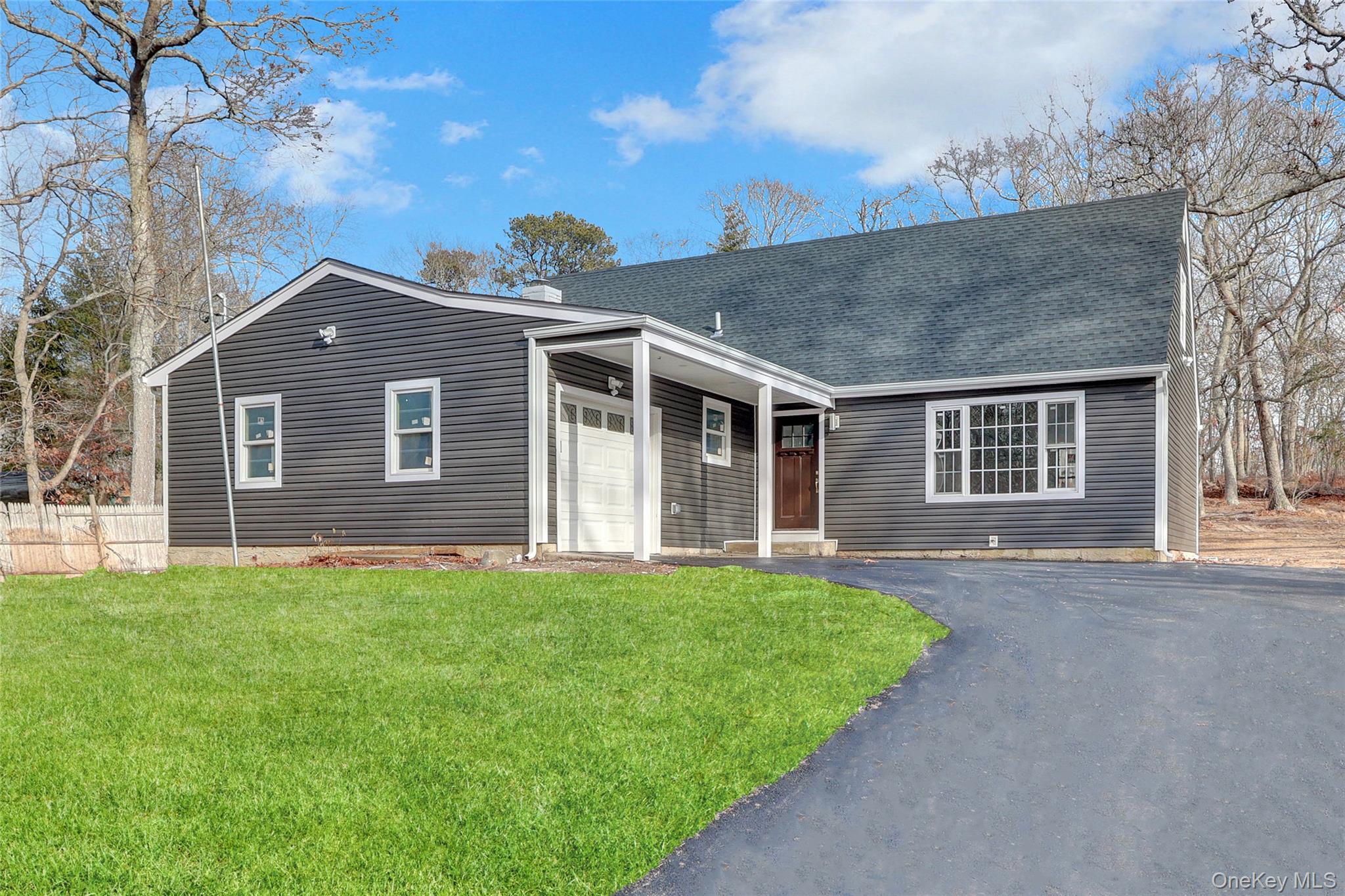 321 Smith Road Shirley, NY 11967 - Photo 1 of 1 View of front of home with a front yard, driveway, a shingled roof, and a garage