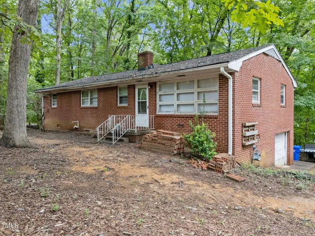a view of house with backyard and seating space