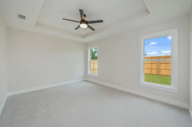 an empty room with windows and closet
