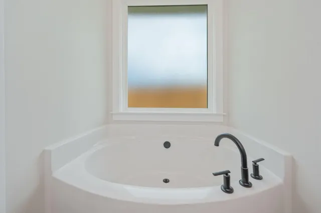 a bathroom with a shower and a sink