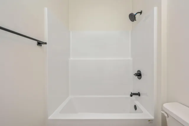 a room that has a bed and a chair in it