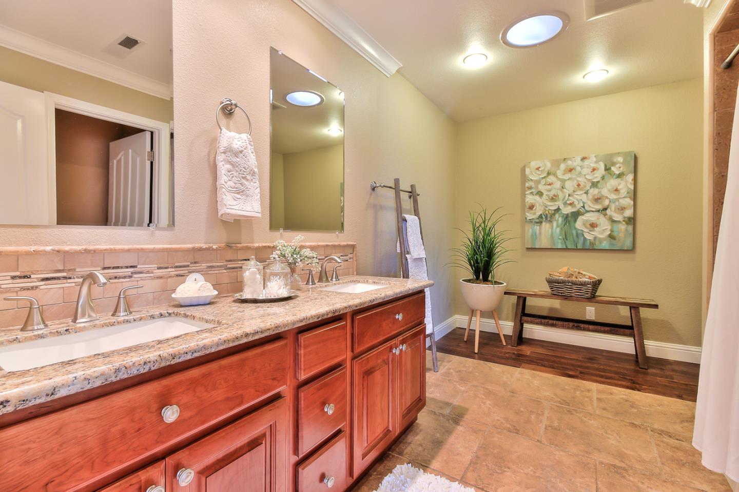 10415 New Avenue Gilroy, CA 95020 - Photo 20 of 55 a spacious bathroom with a granite countertop sink a mirror and a
