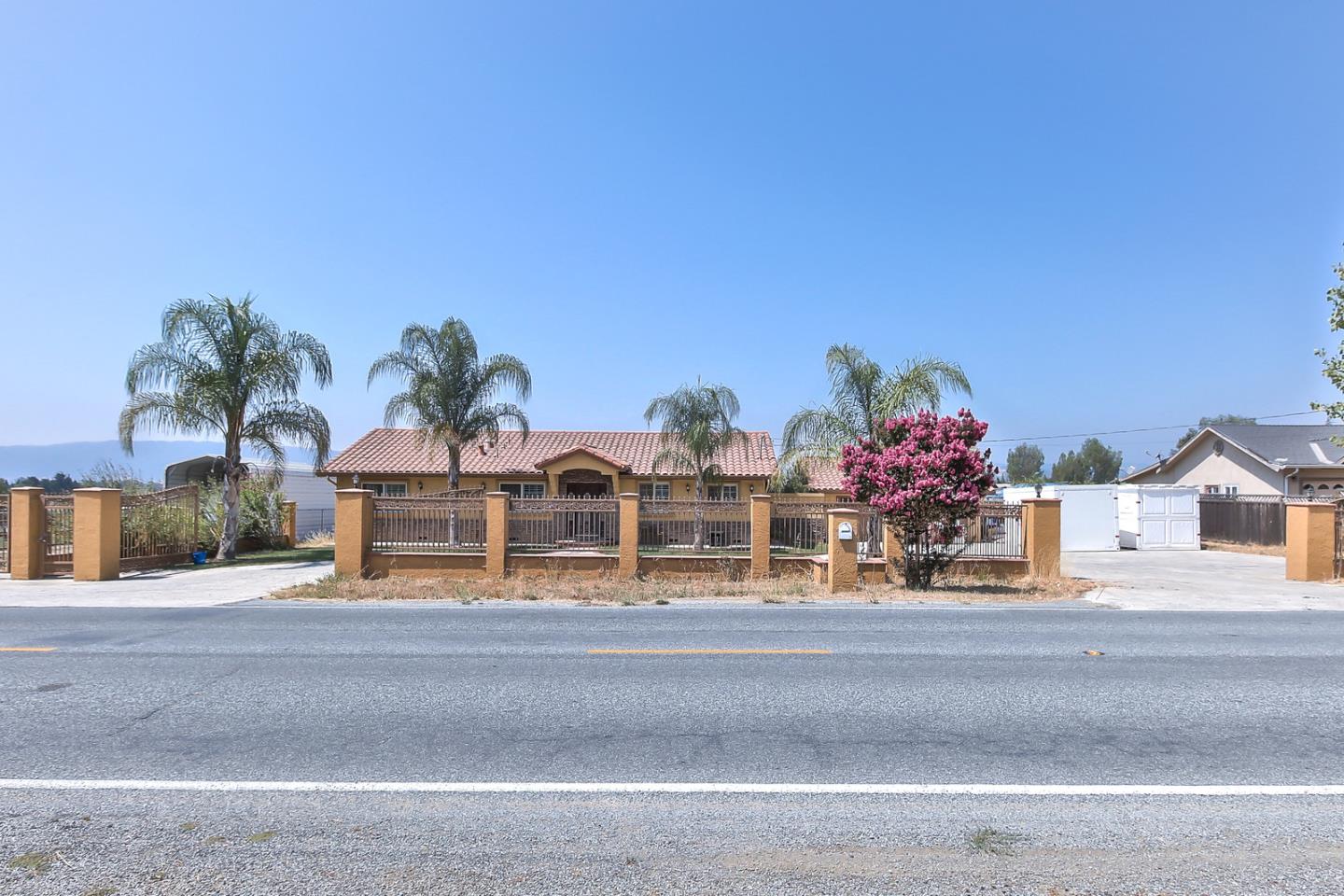 10415 New Avenue Gilroy, CA 95020 - Photo 5 of 55 a front view of white house with glass top table and chairs