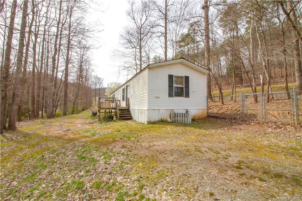 759 Girls Scout Camp Road Mill Spring, NC 28756 - Photo 3 of 23 a house with trees in the background