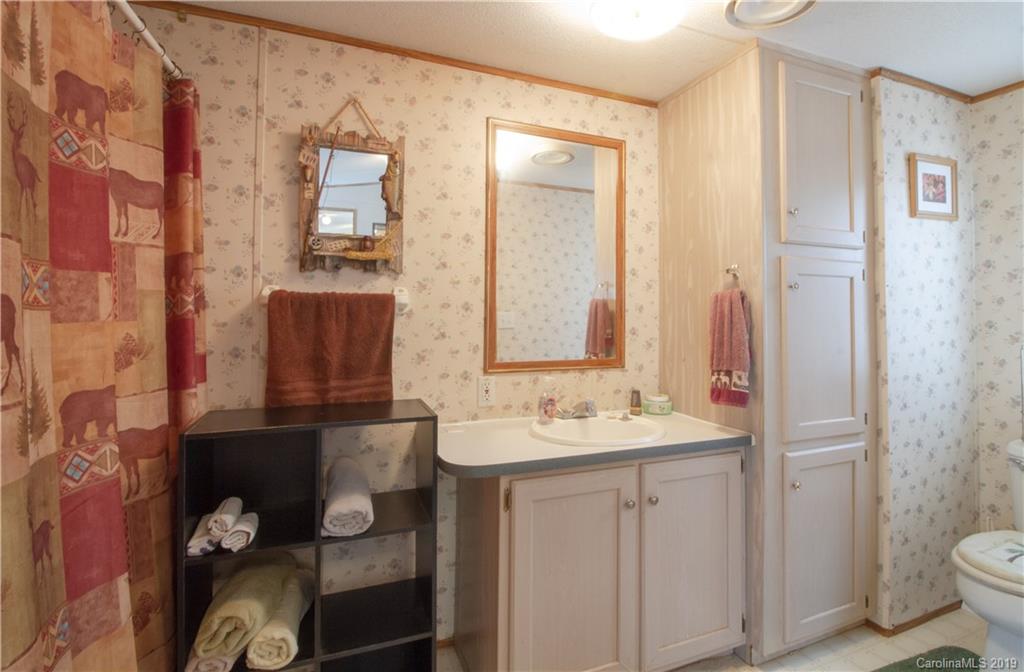 759 Girls Scout Camp Road Mill Spring, NC 28756 - Photo 22 of 23 a bathroom with a sink toilet and shower