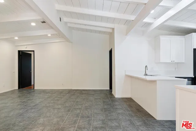a view of a kitchen with refrigerator and microwave