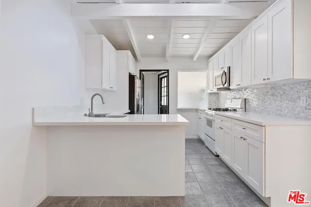 a kitchen with a refrigerator and a sink