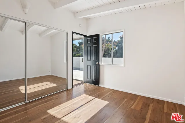 a view of a room with wooden floor and closet
