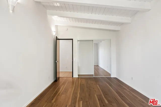 a view of balcony with wooden floor