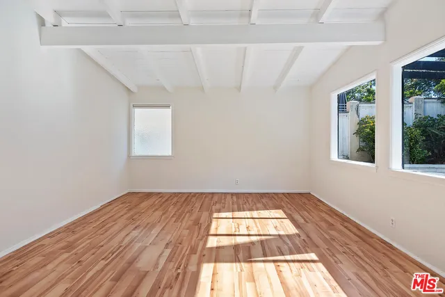 a view of an empty room and wooden floor