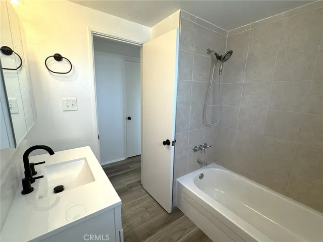 a bathroom with a tub a sink and a shower