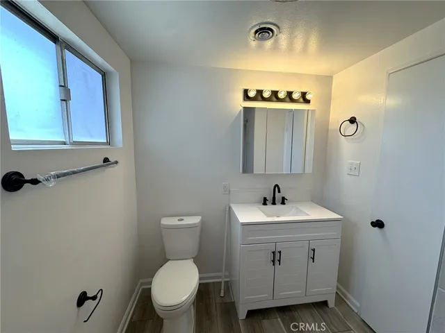 a bathroom with a sink toilet and a mirror