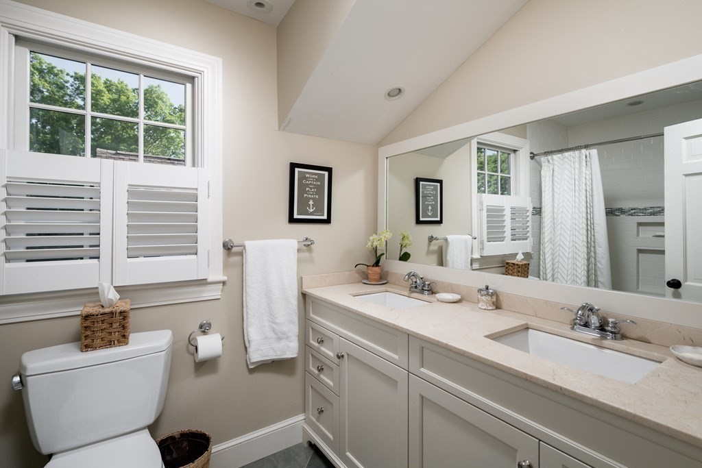 26 Talbot Road Hingham, MA 02043 - Photo 19 of 40 a bathroom with a double vanity sink a mirror and a bathtub
