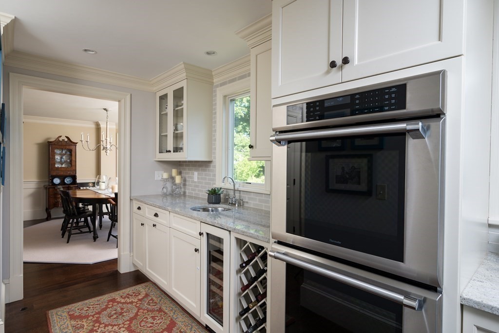 26 Talbot Road Hingham, MA 02043 - Photo 9 of 40 a kitchen with granite countertop a stove microwave and cabinets