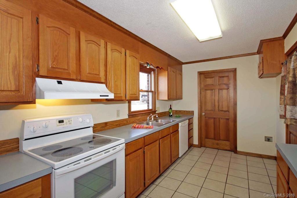 2095 Sides Road Salisbury, NC 28146 - Photo 11 of 25 a kitchen with a sink stove and cabinets