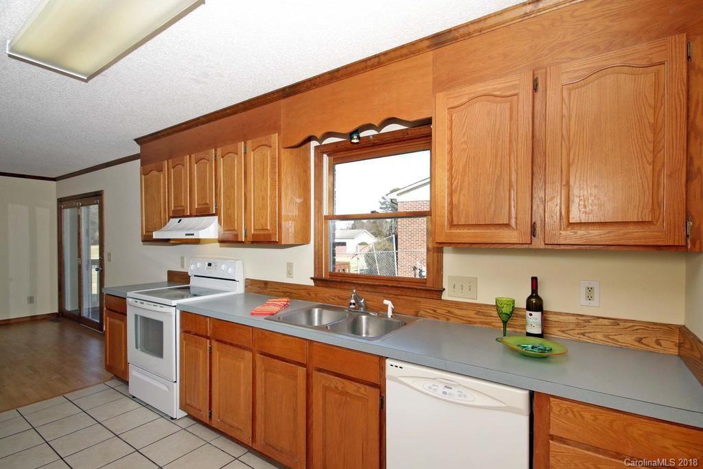 2095 Sides Road Salisbury, NC 28146 - Photo 13 of 25 a kitchen with stainless steel appliances granite countertop a sink stove and cabinets