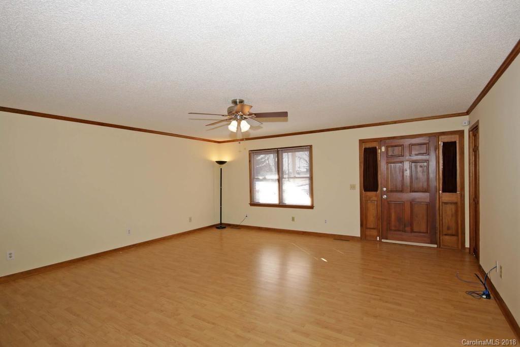 2095 Sides Road Salisbury, NC 28146 - Photo 4 of 25 an empty room with chandelier fan and windows