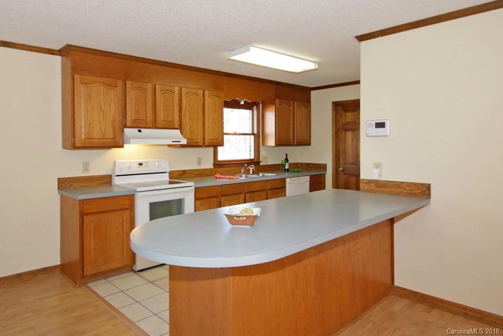 2095 Sides Road Salisbury, NC 28146 - Photo 10 of 25 a kitchen with stainless steel appliances granite countertop a sink a stove and a refrigerator